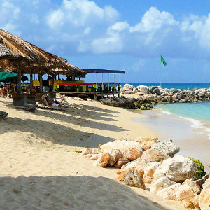 Colorful beach bar, straw huts white sandy beach location in St. Martin
