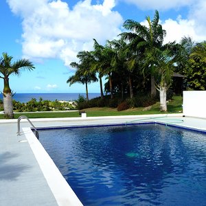 Square swimming pool on veranda of modern villa on Caribbean Island