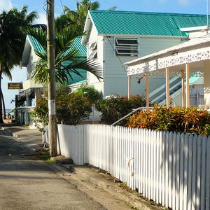 Picked white fence along street location in Barbados