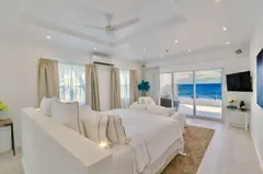bedroom all white with view to ocean