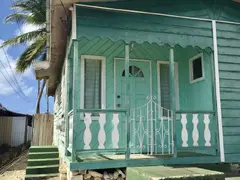 Chattelhouse From Wood In Turquoise Color With Small Porch Before Entrance Door