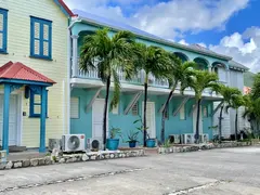 Colorful French Colonial Style Houses With Porches Lined Up Along A Village Street In Saint Martin