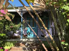 Colourful Chattelhouse In Barbados Overgrown By Pink Flower Bushes