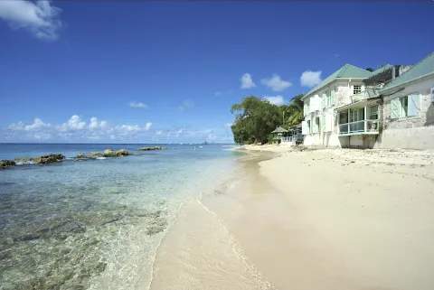 traditional coral stone building with beach restaurant and attached villa resort