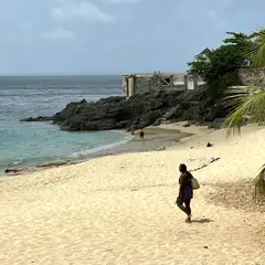 Sandy Beach With Massive Rocks And Old Stairs