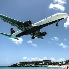 plane over Sint Maarten beach near airport before landing