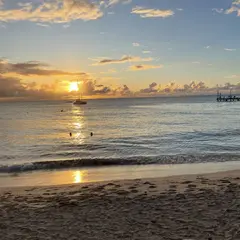 sunset with beautiful colors on beach and over calm caribbean sea
