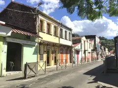 Traditional Old Stone Houses Painted In Multi Colors Lined Along A Quiet Village Street In Martinique