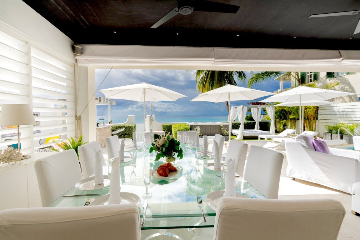 Barbados white beach house living room open to terrace and sea view