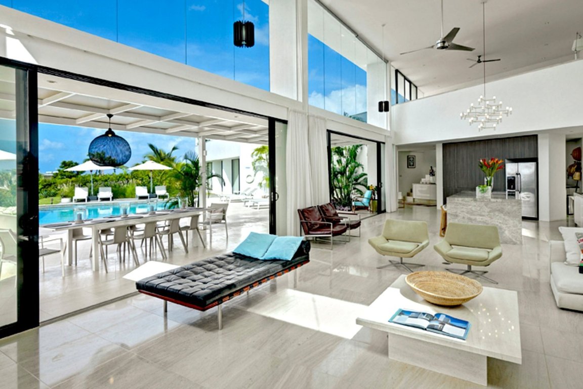 Contemporary open concept living room with bauhaus furniture sliding glass doors
