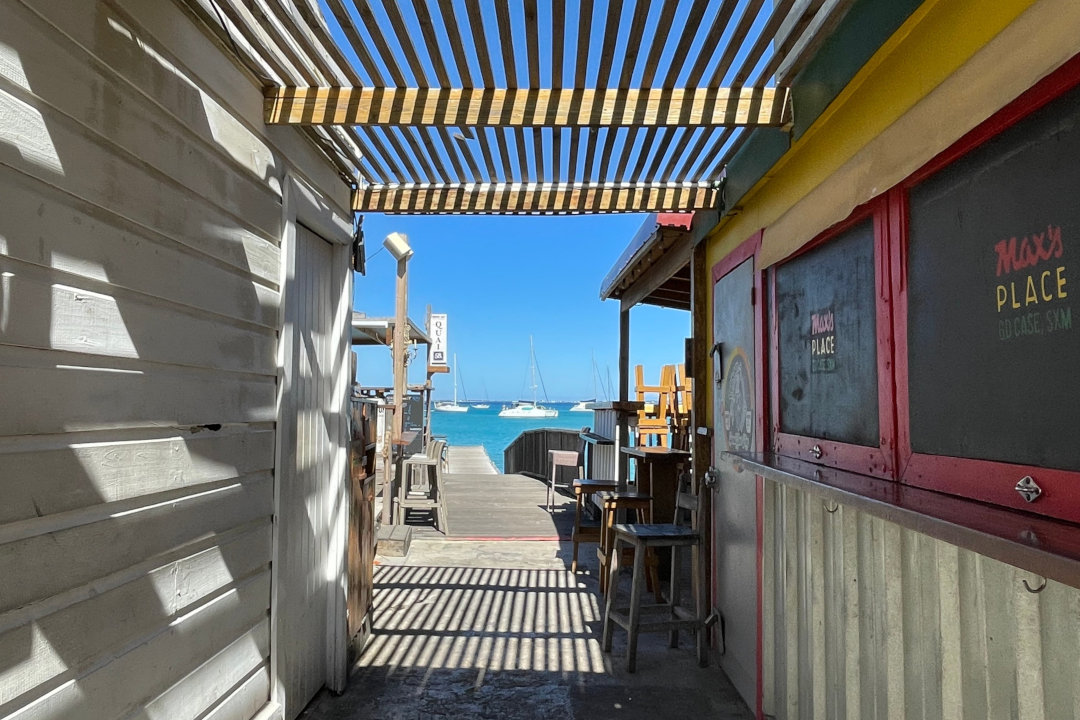 wooden jettie on white beach