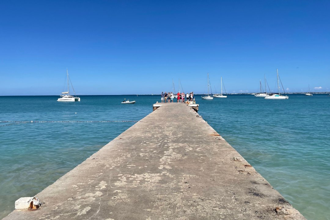 Stone pier in grand case for fisher men in barques and visitors on yachts