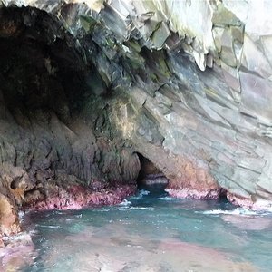 Cave, rock formation in the Caribbean, entrance with clear water