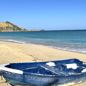 Fishing boot on caribbean sandy beach