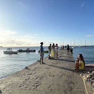 Jetty in Caribbean town with boats