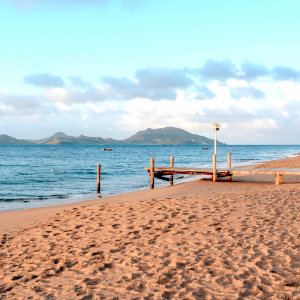 Rustic wooden jetty on deserted beach